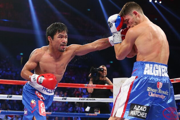 MACAU - NOVEMBER 23:  Manny Pacquiao of the Philippines punches Chris Algieri of the United States during the WBO world welterweight title at The Venetian on November 23, 2014 in Macau, Macau.  (Photo by Chris Hyde/Getty Images)