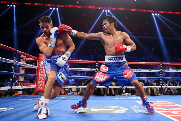 MACAU - NOVEMBER 23:  Manny Pacquiao of the Philippines punches Chris Algieri of the United States during the WBO world welterweight title at The Venetian on November 23, 2014 in Macau, Macau.  (Photo by Chris Hyde/Getty Images)