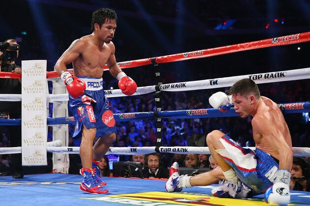 MACAU - NOVEMBER 23:  Manny Pacquiao of the Philippines knockes down Chris Algieri of the United States during the world welterweight title at The Venetian on November 23, 2014 in Macau, Macau.  (Photo by Chris Hyde/Getty Images)