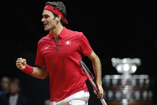 Switzerland's Roger Federer clenches his fist after a winning point as he plays France's Richard Gasquet during the Davis Cup final match opposing France to Switzerland in Lille, northern France, Sunday, Nov.23, 2014. (AP Photo/Christophe Ena)