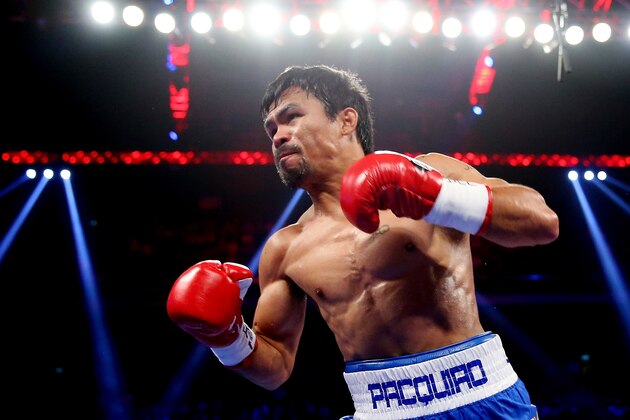 MACAU - NOVEMBER 23:  Manny Pacquiao of the Philippines punches Chris Algieri of the United States during the WBO world welterweight title at The Venetian on November 23, 2014 in Macau, Macau.  (Photo by Chris Hyde/Getty Images)