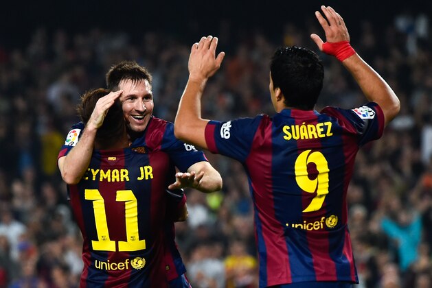 BARCELONA, SPAIN - NOVEMBER 22:  Lionel Messi of FC Barcelona celebrates with his teammates Neymar (L) and Luis Suarez of FC Barcelona after scoring his team's fourth goal during the La Liga match between FC Barcelona and Sevilla FC at Camp Nou on November 22, 2014 in Barcelona, Spain. Lionel Messi beat the  number of goal in the Spanish La Liga of Telmo Zarra scoring his 252nd goal.  (Photo by David Ramos/Getty Images)