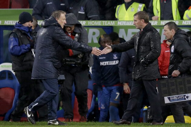 Crystal Palace's manager Neil Warnock, left, shakes hands with Liverpool's manager Brendan Rodgers at the end of the English Premier League soccer match between Crystal Palace and Liverpool at Selhurst Park stadium in London, Sunday, Nov. 23, 2014. Crystal Palace won 3-1.  (AP Photo/Matt Dunham)