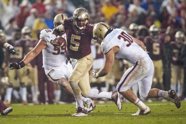 TALLAHASSEE, FL - NOVEMBER 22: Quarterback Jameis Winston #5 of the Florida State Seminoles looks for a hale in the Boston College Eagles line during the game at Doak Campbell Stadium on November 22, 2014 in Tallahassee, Florida. The Seminoles defeated the Eagles 20-17. (Photo by Jeff Gammons/Getty Images)