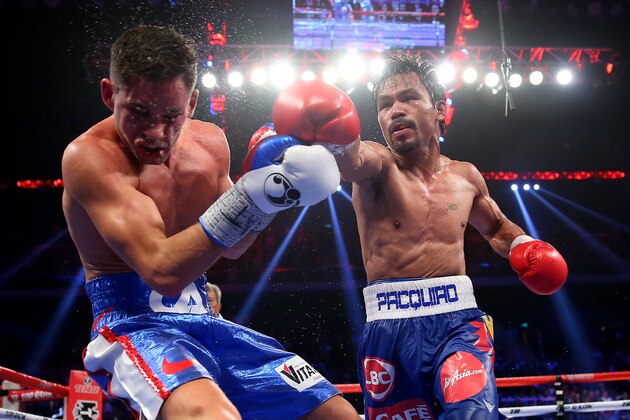 MACAU - NOVEMBER 23:  Manny Pacquiao of the Philippines punches Chris Algieri of the United States during the WBO world welterweight title at The Venetian on November 23, 2014 in Macau, Macau.  (Photo by Chris Hyde/Getty Images)