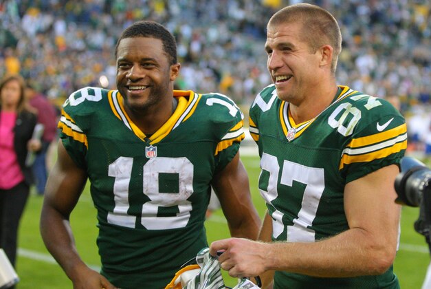 Sep 14, 2014; Green Bay, WI, USA; Green Bay Packers wide receiver Randall Cobb (18) and wide receiver Jordy Nelson (87) celebrate after the game against the New York Jets at Lambeau Field. Green Bay won 31-24. Mandatory Credit: Dennis Wierzbicki-USA TODAY Sports