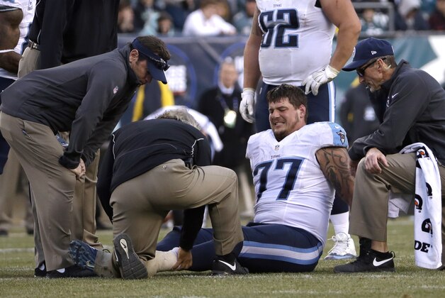 Tennessee Titans' Taylor Lewan lies injured on the field during the second half of an NFL football game against the Philadelphia Eagles, Sunday, Nov. 23, 2014, in Philadelphia. (AP Photo/Michael Perez)