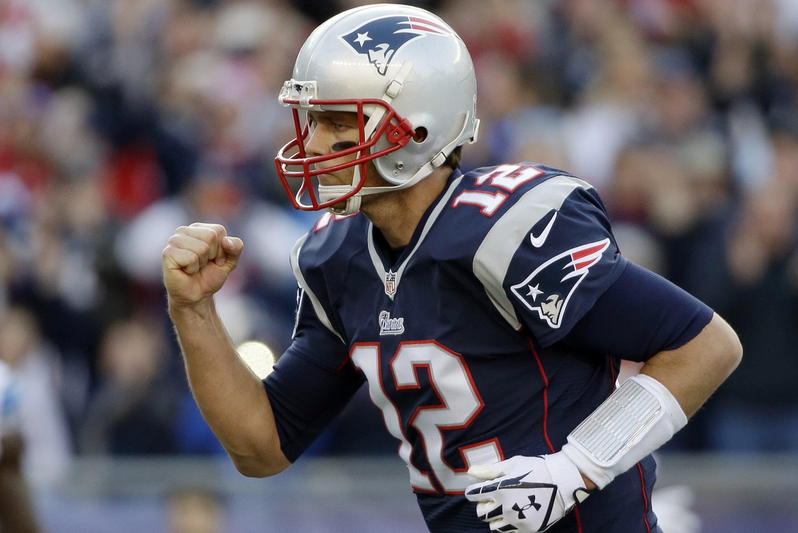 New England Patriots quarterback Tom Brady celebrates his second touchdown pass to Timothy Wright in the first half of an NFL football game against the Detroit Lions, Sunday, Nov. 23, 2014, in Foxborough, Mass. (AP Photo/Steven Senne)