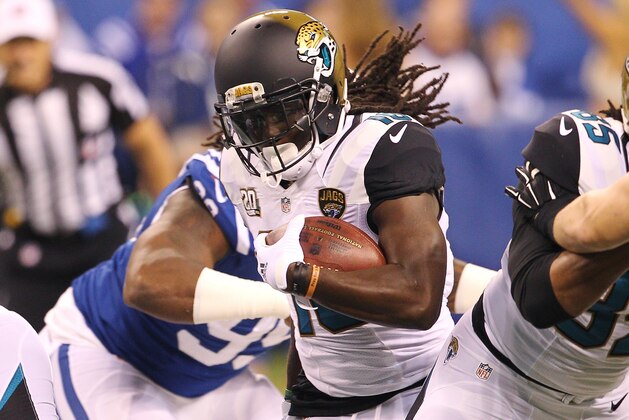 Nov 23, 2014; Indianapolis, IN, USA; Jacksonville Jaguars running back Denard Robinson (16) runs the ball during the first quarter against the Indianapolis Colts at Lucas Oil Stadium. Mandatory Credit: Pat Lovell-USA TODAY Sports