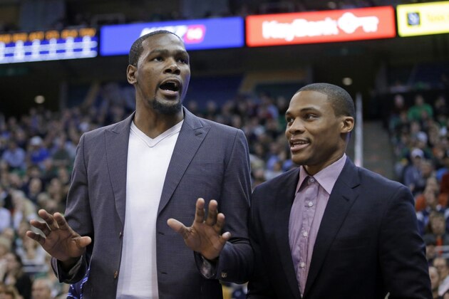 Oklahoma City Thunder's Kevin Durant, left, speaks to the crowd as Russell Westbrook, right, listens during the first quarter of an NBA basketball game against the Utah Jazz on Tuesday, Nov. 18, 2014, in Salt Lake City. (AP Photo/Rick Bowmer)