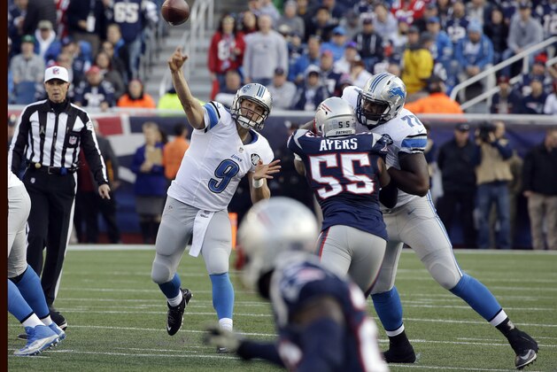 Detroit Lions quarterback Matthew Stafford (9) passes over New England Patriots linebacker Akeem Ayers (55) in the first half of an NFL football game Sunday, Nov. 23, 2014, in Foxborough, Mass. (AP Photo/Stephan Savoia)