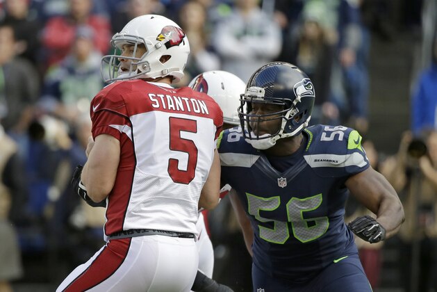 Seattle Seahawks defensive end Cliff Avril sacks Arizona Cardinals quarterback Drew Stanton (5) in the first half of an NFL football game, Sunday, Nov. 23, 2014, in Seattle. (AP Photo/Elaine Thompson)