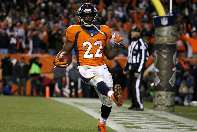Denver Broncos running back C.J. Anderson (22) celebrate his touchdown run against the Miami Dolphins during the second half of an NFL football game, Sunday, Nov. 23, 2014, in Denver. (AP Photo/Jack Dempsey)