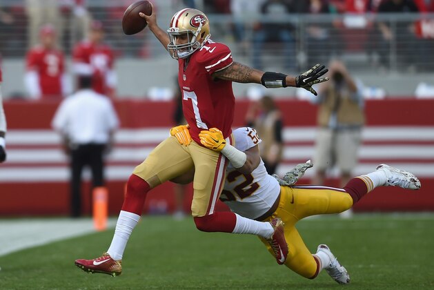 SANTA CLARA, CA - NOVEMBER 23:  Colin Kaepernick #7 of the San Francisco 49ers fights a tackle from Keenan Robinson #52 of the Washington Redskins at Levi's Stadium on November 23, 2014 in Santa Clara, California.  (Photo by Thearon W. Henderson/Getty Images)