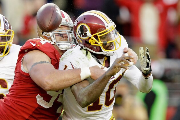 SANTA CLARA, CA - NOVEMBER 23: Justin Smith #94 of the San Francisco 49ers forces a fumble from Robert Griffin III #10 of the Washington Redskins in the fourth quarter at Levi's Stadium on November 23, 2014 in Santa Clara, California.  (Photo by Ezra Shaw/Getty Images)
