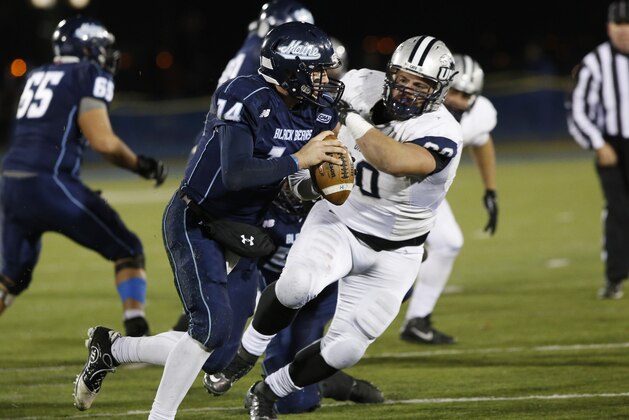 New Hampshire Wildcats defensive tackle Matt Kaplan (60) bears down on Maine Black Bears quarterback Drew Belcher (14) during the second half of an NCAA college football game, Saturday, Nov. 22, 2014, at Alfond Stadium in Orono, Maine. (AP Photo/Robert F. Bukaty)