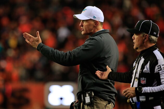 DENVER, CO - NOVEMBER 23:  Head coach Joe Philbin of the Miami Dolphins discusses a play with a line judge during a game between the Denver Broncos and the Miami Dolphins at Sports Authority Field at Mile High on November 23, 2014 in Denver, Colorado.  (Photo by Doug Pensinger/Getty Images)