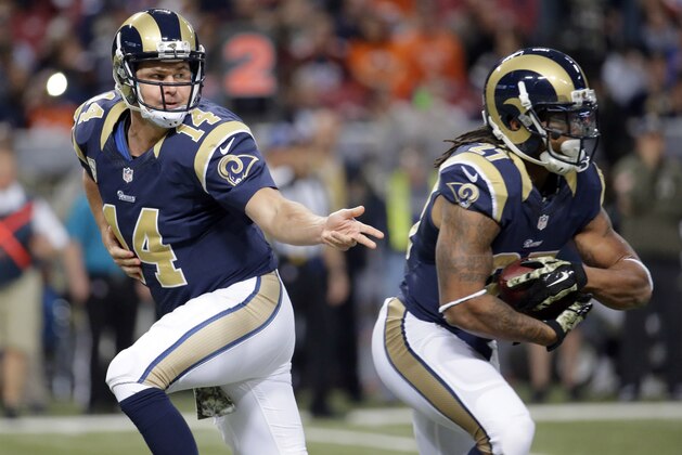 St. Louis Rams quarterback Shaun Hill, left, hands off to running back Tre Mason during the first quarter of an NFL football game against the Denver Broncos, Sunday, Nov. 16, 2014, in St. Louis. (AP Photo/Charlie Riedel)