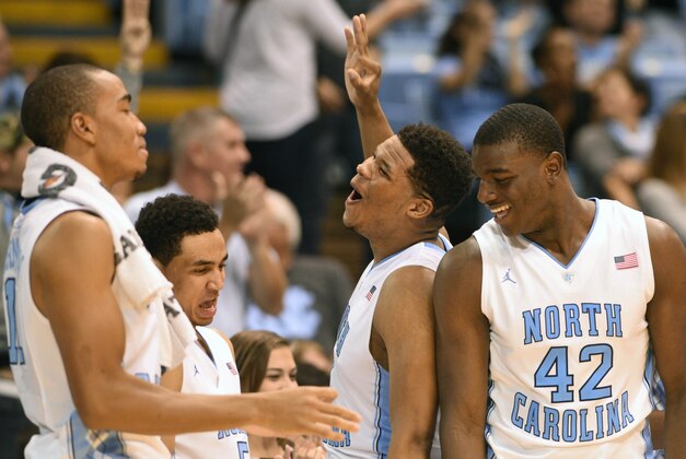 Nov 16, 2014; Chapel Hill, NC, USA; North Carolina Tar Heels forward Kennedy Meeks (3) and forward Joel James (42) and forward Brice Johnson (11) and guard Marcus Paige (5) celebrate from the bench in the second half against Robert Morris Colonials at Dean E. Smith Center. The Tar Heels won 103-59. Mandatory Credit: Evan Pike-USA TODAY Sports