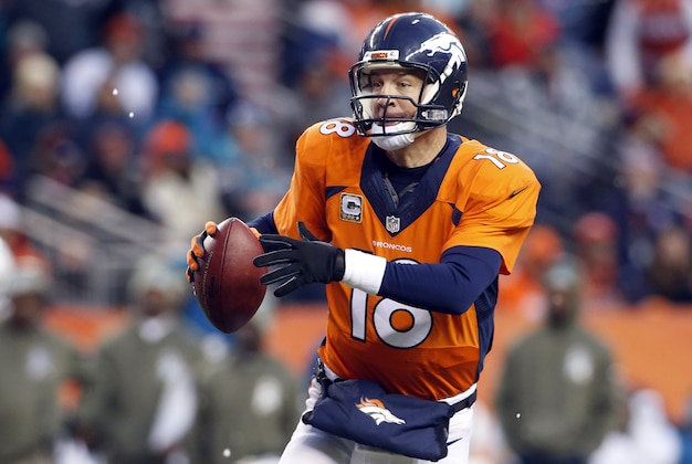 Nov 23, 2014; Denver, CO, USA; Denver Broncos quarterback Peyton Manning (18) scrambles out of the pocket during the second half against the Miami Dolphins at Sports Authority Field at Mile High.  The Broncos won 39-36. Mandatory Credit: Chris Humphreys-USA TODAY Sports