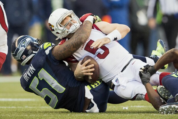 Nov 23, 2014; Seattle, WA, USA; Seattle Seahawks outside linebacker Bruce Irvin (51) sacks Arizona Cardinals quarterback Drew Stanton (5) during the second half at CenturyLink Field. Seattle defeated Arizona 19-3. Mandatory Credit: Steven Bisig-USA TODAY Sports