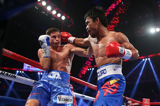 MACAU - NOVEMBER 23:  Manny Pacquiao of the Philippines punches Chris Algieri of the United States during the WBO world welterweight title at The Venetian on November 23, 2014 in Macau, Macau.  (Photo by Chris Hyde/Getty Images)
