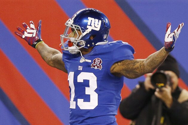 New York Giants wide receiver Odell Beckham Jr. (13) reacts after making a one-handed catch for a touchdown against the Dallas Cowboys in the first quarter of an NFL football game, Sunday, Nov. 23, 2014, in East Rutherford, N.J. (AP Photo/Kathy Willens)