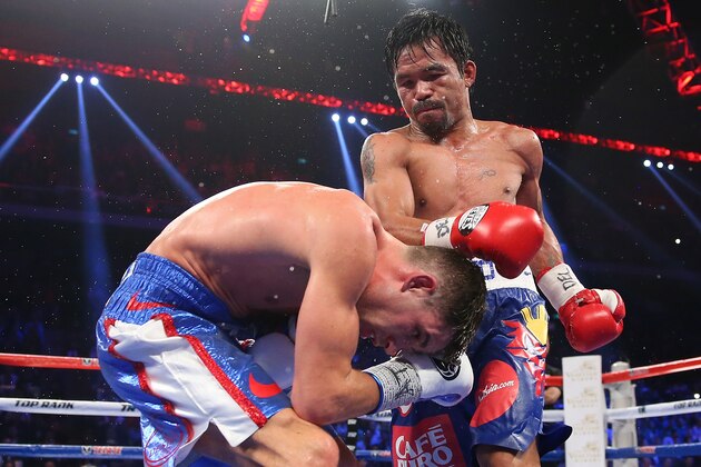 MACAU - NOVEMBER 23:  Manny Pacquiao of the Philippines punches Chris Algieri of the United States during the WBO world welterweight title at The Venetian on November 23, 2014 in Macau, Macau.  (Photo by Chris Hyde/Getty Images)