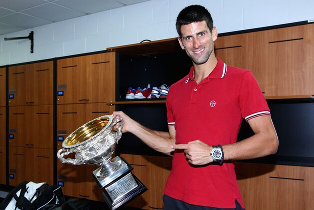 MELBOURNE, AUSTRALIA - JANUARY 29: Novak Djokovic of Serbia poses with the Norman Brookes Challenge Cup in the players locker room after winning the men's final match against Rafael Nadal of Spain during day fourteen of the 2012 Australian Open at Melbourne Park on January 29, 2012 in Melbourne, Australia.  (Photo by Clive Brunskill-Pool/Getty Images)