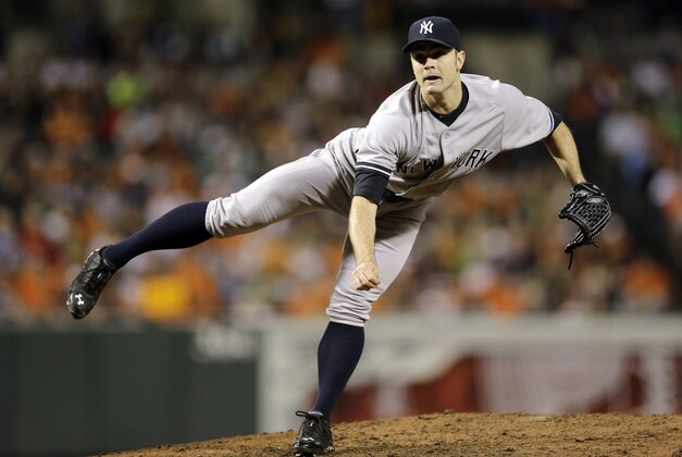 New York Yankees relief pitcher David Robertson follows through on a pitch to the Baltimore Orioles in the ninth inning of a baseball game, Sunday, Sept. 14, 2014, in Baltimore. (AP Photo/Patrick Semansky)