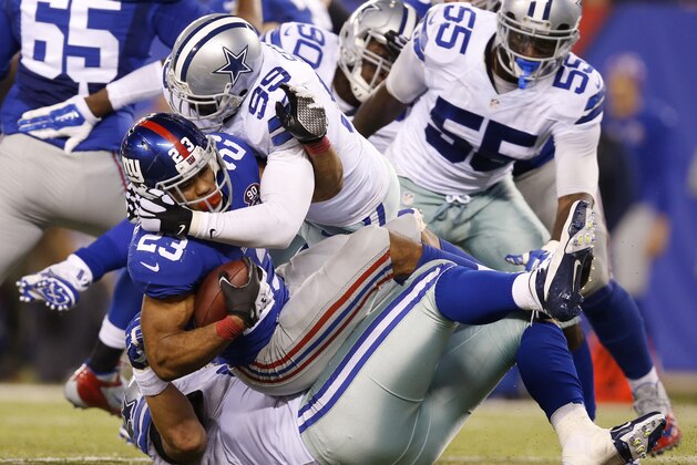 New York Giants running back Rashad Jennings (23) is tackled by Dallas Cowboys George Selvie in the fourth quarter of an NFL football game, Sunday, Nov. 23, 2014, in East Rutherford, N.J. The Cowboys won 31-28. (AP Photo/Kathy Willens)