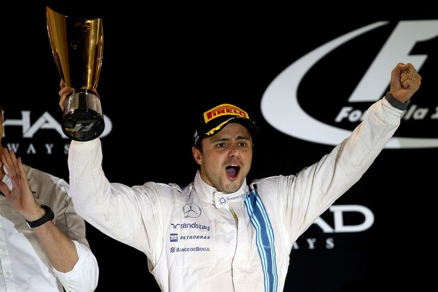 ABU DHABI, UNITED ARAB EMIRATES - NOVEMBER 23:  Felipe Massa of Brazil and Williams celebrates on the podium after finishing second in the Abu Dhabi Formula One Grand Prix at Yas Marina Circuit on November 23, 2014 in Abu Dhabi, United Arab Emirates.  (Photo by Clive Rose/Getty Images)