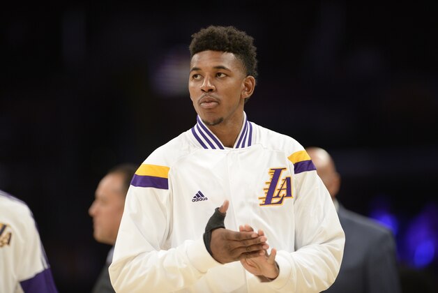 Los Angeles Lakers forward Nick Young warms up before the start an NBA basketball game against the Denver Nuggets, Sunday, Nov. 23, 2014, in Los Angeles.(AP Photo/Gus Ruelas)