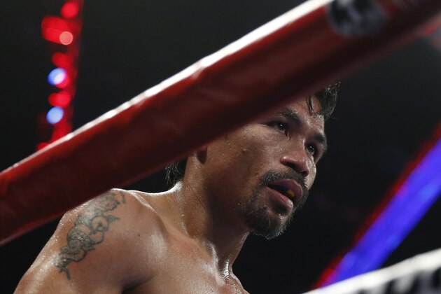 WBO welterweight champion Manny Pacquiao of the Philippines gestures during his world welterweight title boxing match against WBO junior welterweight champion Chris Algieri of the U.S. at the Venetian Macao in Macau, Sunday, Nov. 23, 2014. (AP Photo/Kin Cheung)