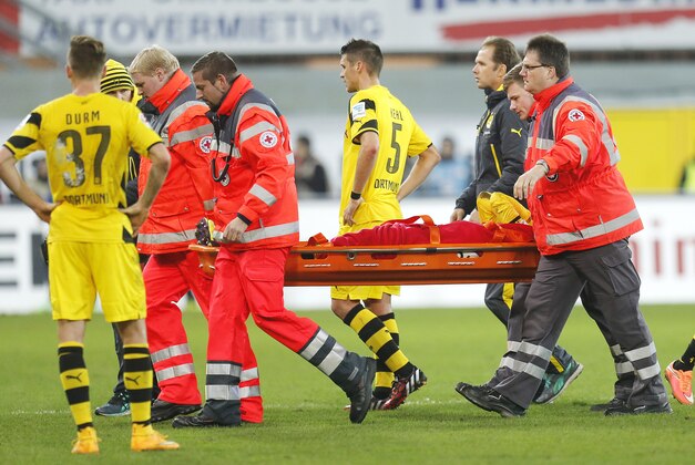 Dortmund's Marco Reus is carried off the pitch on a stretcher during the German first division Bundesliga soccer match between SC Paderborn 07 and Borussia Dortmund in Paderborn, Germany, Saturday, Nov.22, 2014. (AP Photo/Michael Probst)