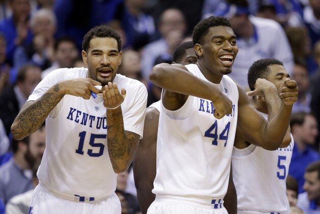 Kentucky's Willie Cauley-Stein (15) and Dakari Johnson (44) celebrate from the bench late in the second half of an NCAA college basketball game against Kansas, Tuesday, Nov. 18, 2014, in Indianapolis. Kentucky won 72-40. (AP Photo/Darron Cummings)