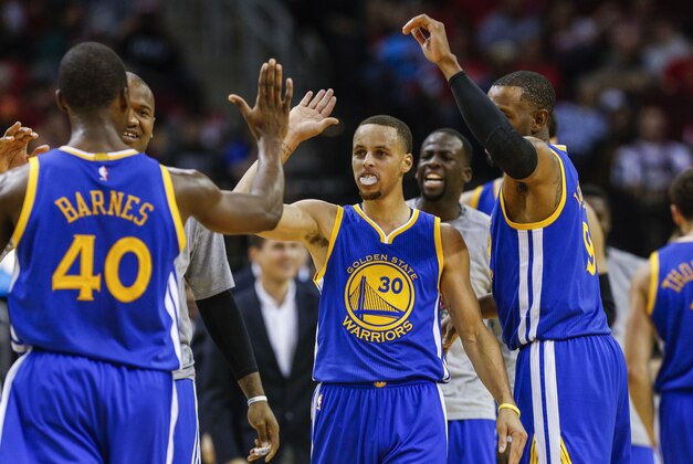 Nov 8, 2014; Houston, TX, USA; Golden State Warriors guard Stephen Curry (30) celebrates with teammates after a play during the third quarter against the Houston Rockets at Toyota Center. Mandatory Credit: Troy Taormina-USA TODAY Sports