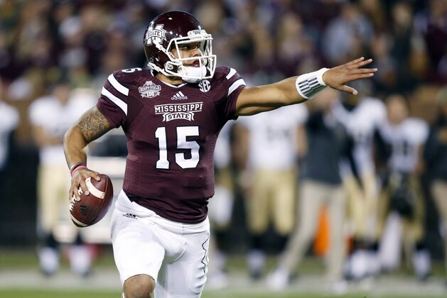 Mississippi State quarterback Dak Prescott (15) directs his blockers as he tries to find an open player in the first half of an NCAA college football game against Vanderbilt, Saturday, Nov. 22, 2014, in Starkville, Miss. (AP Photo/Rogelio V. Solis)