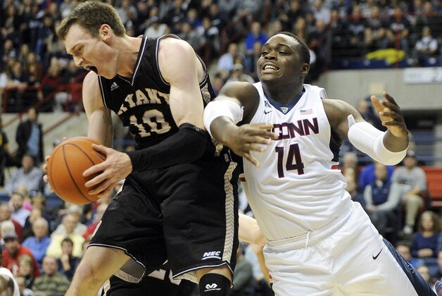 Bryant's Joe O'Shea (10) grabs a rebound from Connecticut's Rakim Lubin (14) during the first half of an NCAA college basketball game in Storrs, Conn., on Friday, Nov. 14, 2014. (AP Photo/Fred Beckham)