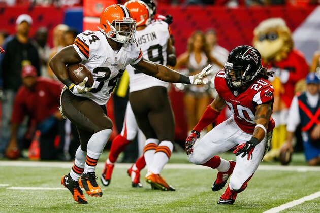ATLANTA, GA - NOVEMBER 23: Isaiah Crowell #34 of the Cleveland Browns stiff arms Dwight Lowery #20 of the Atlanta Falcons on a touchdown run in the second half at the Georgia Dome on November 23, 2014 in Atlanta, Georgia.  (Photo by Kevin C. Cox/Getty Images)