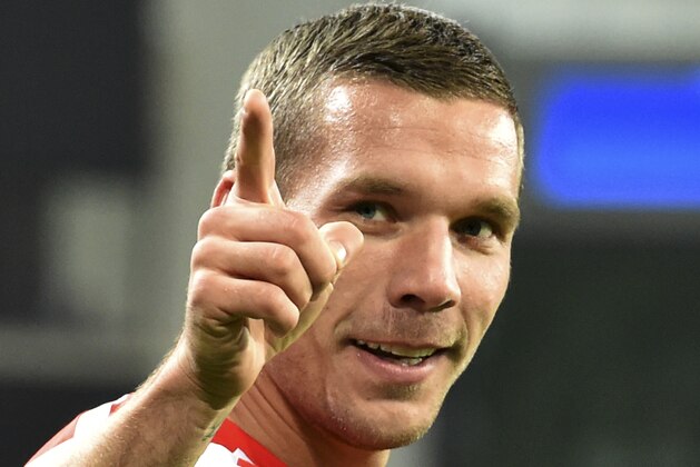Arsenal's Lukas Podolski gestures to fans after the Group D Champions League match between Anderlecht and Arsenal at Constant Vanden Stock Stadium in Brussels, Belgium, Wednesday Oct. 22, 2014. Arsenal won the match with a 2-1 score, Podolski scored his team's second goal. (AP Photo/Geert Vanden Wijngaert)