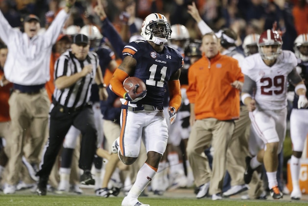 FILE - In this Nov. 30, 2013 file photo, Auburn cornerback Chris Davis (11) returns a field goal attempt 109-yards to score the winning touchdown over Alabama during the second half of an NCAA college football game in Auburn, Ala.Pursuing is punter Cody Mandell (29). Davis's 109-yard return of a missed field goal to beat Alabama was one of the Iron Bowl's and the season's most memorable plays. (AP Photo/Dave Martin, file)