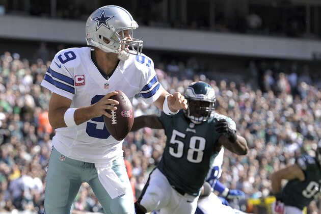 Dallas Cowboys quarterback Tony Romo (9) looks to pass as Philadelphia Eagles outside linebacker Trent Cole (58) chases him during the first half of an NFL football game, Sunday, Oct. 20, 2013, in Philadelphia. (AP Photo/Michael Perez)