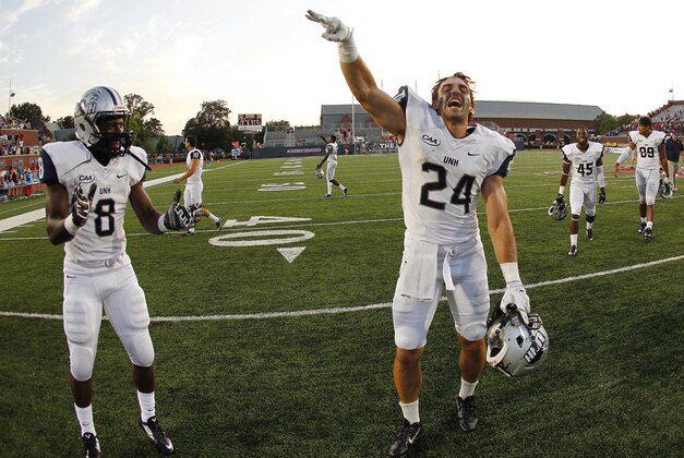 Sep 20, 2014; Richmond, VA, USA; New Hampshire Wildcats wide receiver Mike Kelly (24) and running back Trevon Bryant (8) celebrate after their game against the Richmond Spiders at Robins Stadium. The Wildcats won 29-26. Mandatory Credit: Geoff Burke-USA TODAY Sports