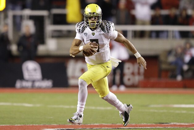 Oregon quarterback Marcus Mariota (8) carries the ball in the second half during an NCAA college football game against Utah Saturday, Nov. 8, 2014, in Salt Lake City. Oregon  won 51-27. (AP Photo/Rick Bowmer)