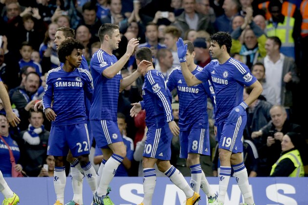 Chelsea's Diego Costa, right, celebrates scoring his side's first goal during the English Premier League soccer match between Chelsea and West Bromwich Albion at Stamford Bridge stadium in London, Saturday, Nov. 22, 2014.  (AP Photo/Matt Dunham)