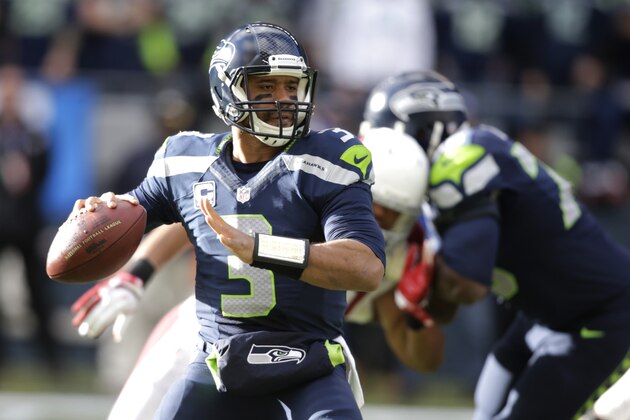 Seattle Seahawks quarterback Russell Wilson looks to pass in the first half of an NFL football game against the Arizona Cardinals, Sunday, Nov. 23, 2014, in Seattle. (AP Photo/Stephen Brashear)