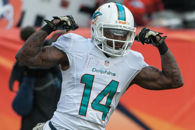 DENVER, CO - NOVEMBER 23:  Wide receiver Jarvis Landry #14 of the Miami Dolphins celebrates a 20-yard reception in the first quarter of a game against the Denver Broncos at Sports Authority Field at Mile High on November 23, 2014 in Denver, Colorado.  (Photo by Dustin Bradford/Getty Images)