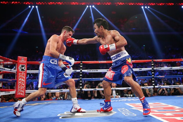 MACAU - NOVEMBER 23:  Manny Pacquiao of the Philippines punches Chris Algieri of the United States during the WBO world welterweight title at The Venetian on November 23, 2014 in Macau, Macau.  (Photo by Chris Hyde/Getty Images)