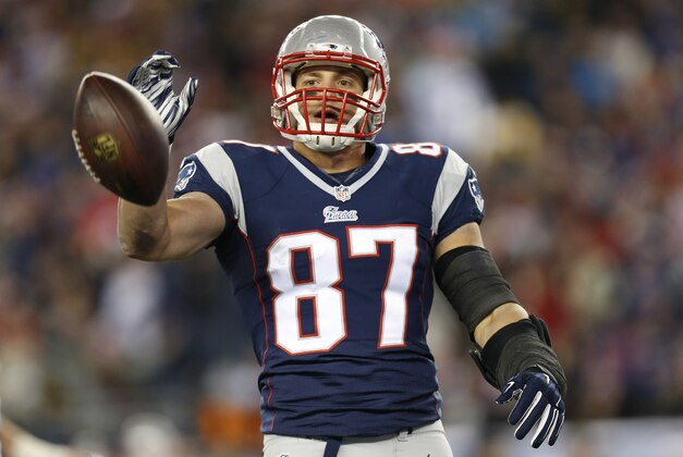 Nov 2, 2014; Foxborough, MA, USA; New England Patriots tight end Rob Gronkowski (87) flips the ball to an official after a reception during the first quarter against the Denver Broncos at Gillette Stadium. Mandatory Credit: Greg M. Cooper-USA TODAY Sports